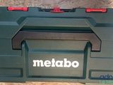 a close up of a green tool box with a red handle
