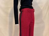 black turtle neck sweater and red pants on a mannequin stand