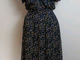 dress made of blue and yellow flowers on a mannequin stand