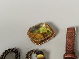 a lot of jewelry that is laying out on the table