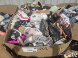 a cardboard box filled with shoes and other items