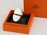 an orange box with a ring inside of it on a white surface