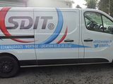 a white van that is parked in front of a building