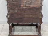 an old wooden table with three drawers on it
