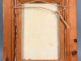 an old picture frame with a rope hanging from it ' s side
