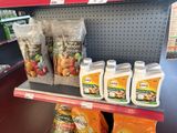 many bottles of liquid on the shelf in the store