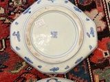 several plates are lined up on a rug on the floor