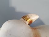 marble figurine of an elephant with a gold ring on its neck