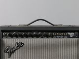 an electric guitar amplifier sitting on top of a wooden table
