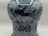 a blue and white vase with a bird on it