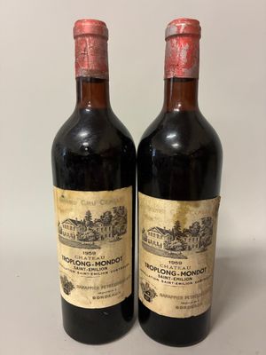 two bottles of wine sitting on top of a white table