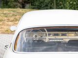 a white car that is parked on the side of the road