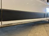 a close up of a white truck with a black stripe