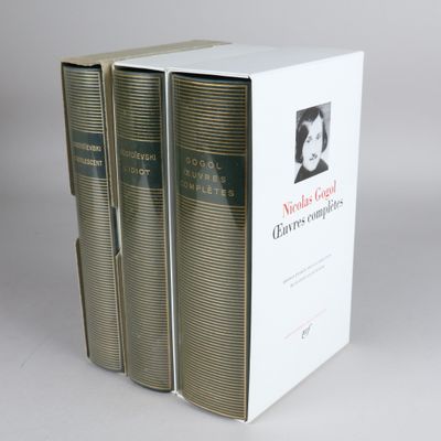 three books sitting on top of a white box on a table