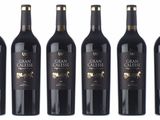 six bottles of red wine are lined up in a row