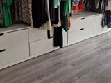 a closet with a lot of clothes on the shelves