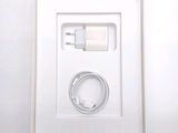 a white box with a charger and a cable in it