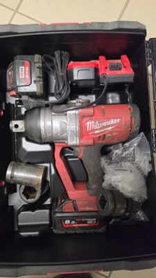 a box with tools in it sitting on a tile floor