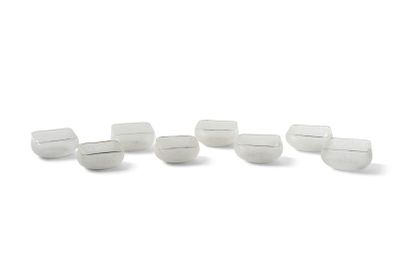 several white plastic cups are lined up on a white surface