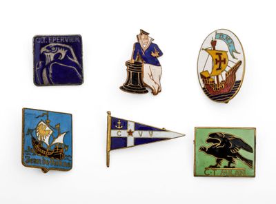 several pins of different types and colors are displayed on a white surface