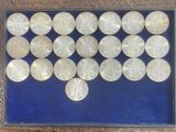 a picture of a display of silver coins in a glass case