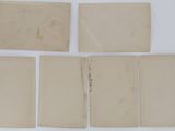 several pieces of old paper sitting on top of a table