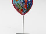 sculpture of a heart with two birds on top of it