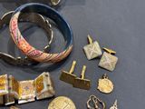 many different types of jewelry on display on the table