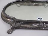 a silver tray with a mirror on it on a table