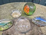 a table that has a glass bowl with a fish inside of it