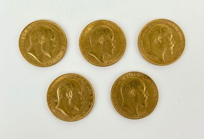 four gold sovereigns, one of which has a crown on it