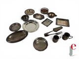 a lot of old silverware on a white surface
