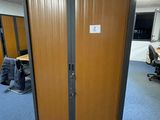 a wooden door in a room with a blue carpet