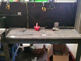 a workbench that has a large piece of metal on top of it