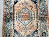 an antique persian rug with a blue and orange design