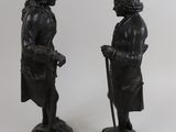 pair of antique cast iron figurines of a gentleman and a woman