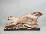 figurine of a running lion on a rock on a white background