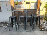 four stools that are sitting on the sidewalk
