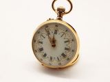 une montre de poche en or avec des chiffres romains