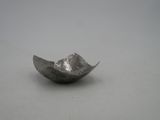a close up of a small metal object on a white surface