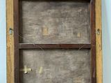 an old wooden cabinet with a glass door on top of it