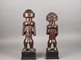 a pair of carved wooden figures of a man and a woman