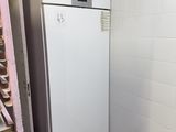 a white refrigerator in the corner of a room