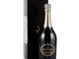 a bottle of champagne in front of a black box