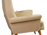 an image of a beige chair with wooden legs and a white background