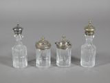 three small glass bottles with silver lids and a silver top