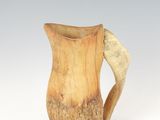 an image of a wooden pitcher with a curved handle