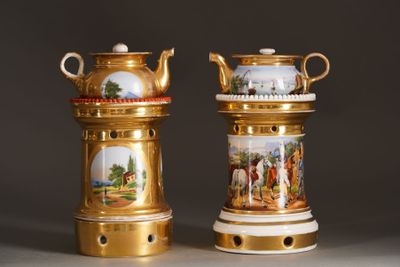two gold vases with pictures of people on them