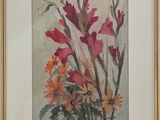 painting of a bouquet of flowers in a gold frame on a white wall