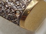 a gold and silver ring with diamonds on it